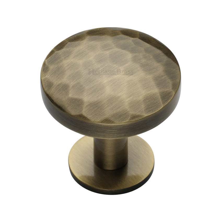Hammered Cabinet Knob in an Antique Brass Finish on a Rose - C3876-AT