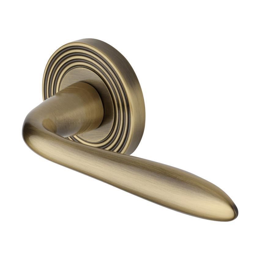 Sutton Reeded Door Handle on a Rose in Antique Brass - RR1752AT