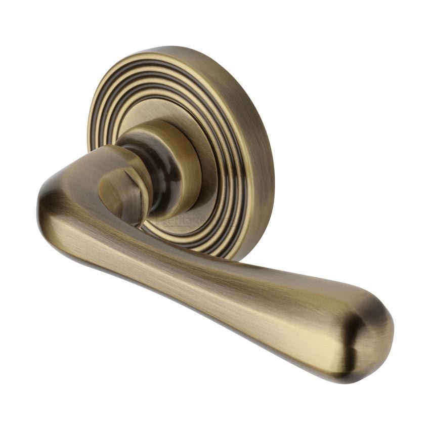 Charlbury Reeded Door Handle on a Rose in Antique Brass - RR3022AT