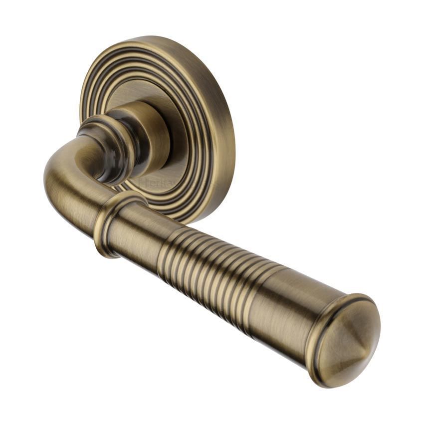 Bridgetown Reeded Door Handle on a Rose in Antique Brass - RR1935AT